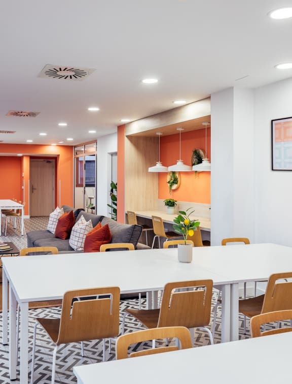 a living room and dining room with white tables and chairs