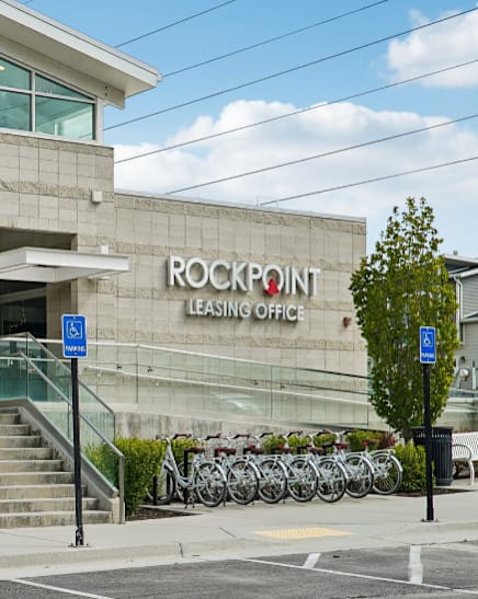 A modern building with glass walls and a sign that reads "Rockpoint Leasing Office".