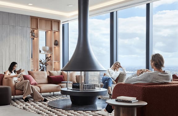 A modern living room with a large window overlooking the city.