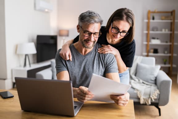 A man and woman are looking at a document at The Crawford Apartments, California
