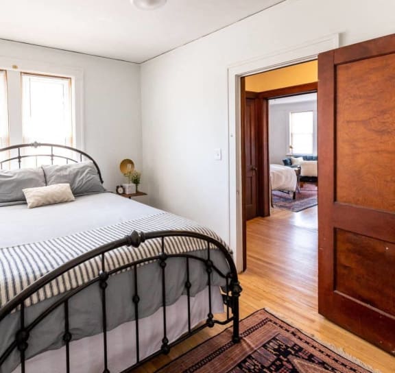 a bedroom with a bed and a door to a bathroom
