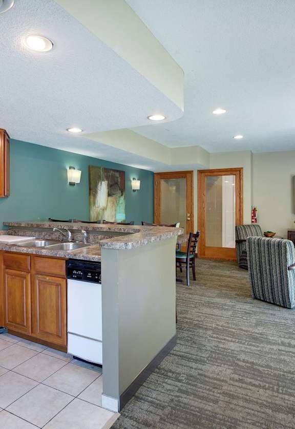 a living room with a kitchen and a dining room at Pebblebrook Flats, Bloomington