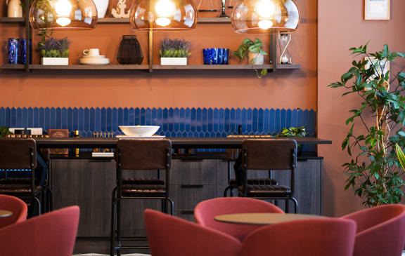 a kitchen with a long counter and bar stools