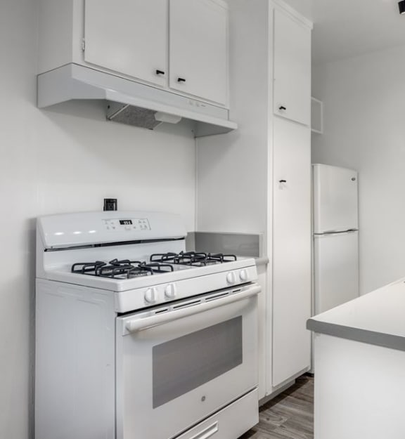 a kitchen with a stove top oven next to a sink