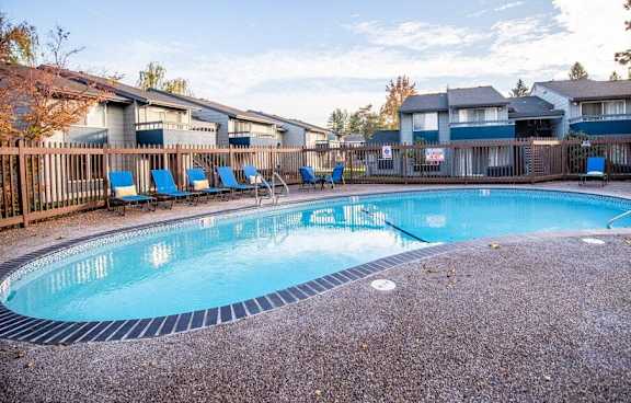 A small round pool surrounded by a fence and trees. at The Lakes at Fife, Fife, WA, 98424