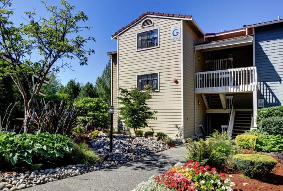 the front of a house with a walkway and a garden at 2000 Lake Washington Apartments in Washington 98056