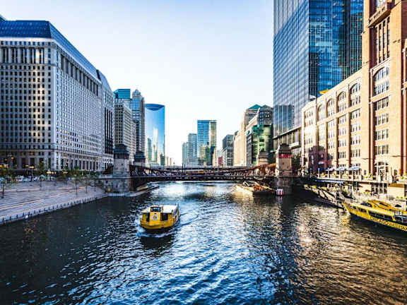 a boat is going down a river in a city