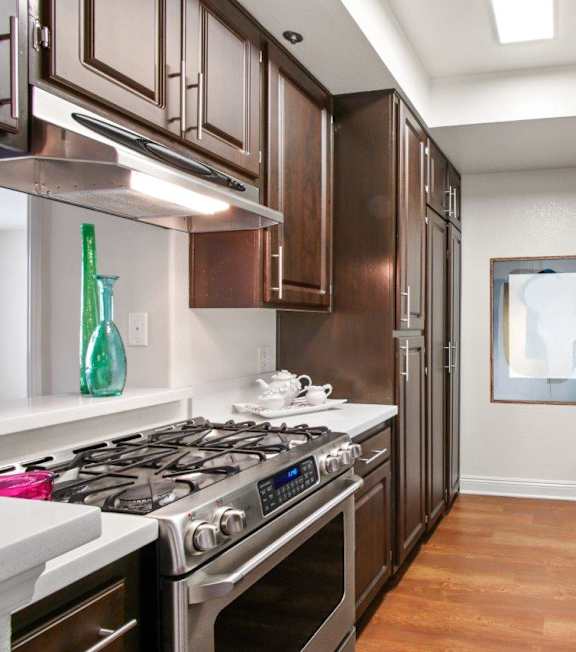 a fully equipped kitchen with stainless steel appliances at Darlington Apartments, Los Angeles