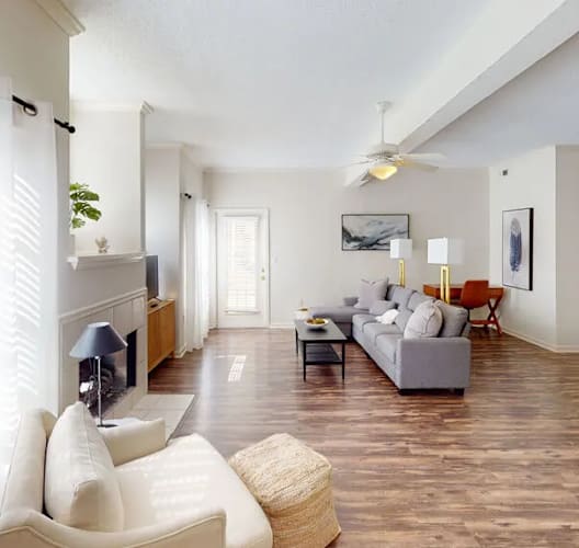A living room with a white couch and a television.