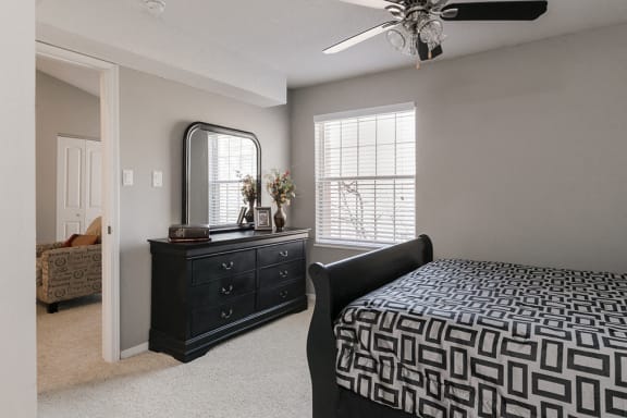 Spacious Carpeted Bedroom with Ceiling Fan