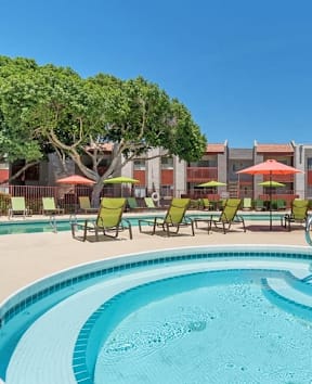our apartments offer a swimming pool with umbrellas at Spring Meadow Apartments, Glendale, AZ, 85302