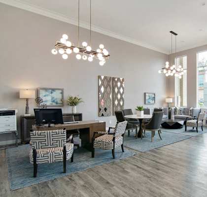 A well-lit room with a wooden floor and a variety of chairs and tables.