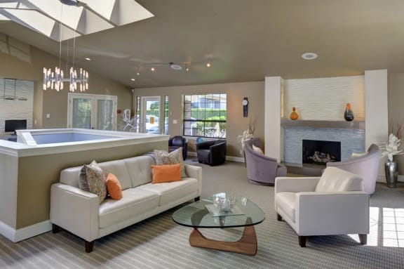 a living room with a fireplace and a pool at 2000 Lake Washington Apartments, WA, 98056