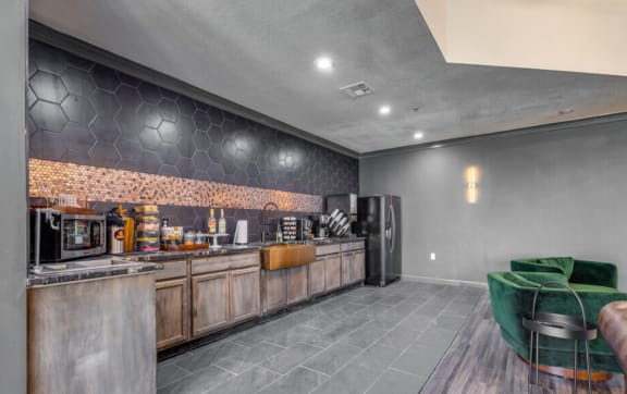 an empty living room with a kitchen in the backgroundat The Lodge Apartments, Tulsa, 74129
