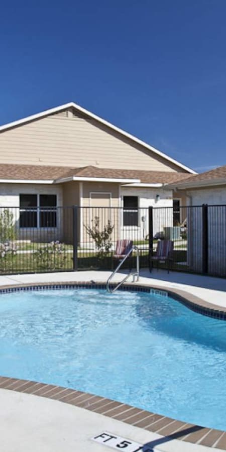 a swimming pool in front of a house