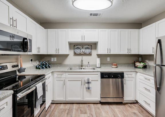 White Cabinetry with Stainless Steel Appliances