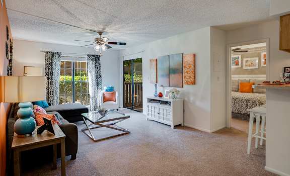 Spacious Living Room with Large Windows and Sliding Patio Door