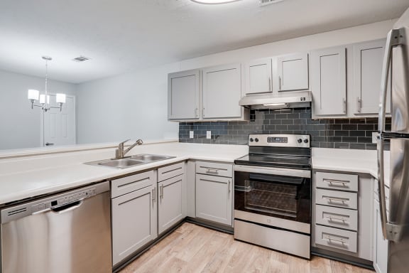 Grey Cabinetry with Stainless Steel Appliances