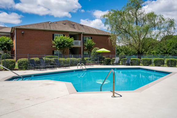 Fenced In Pool Area with Expansive Sundeck and Lounge Chairs