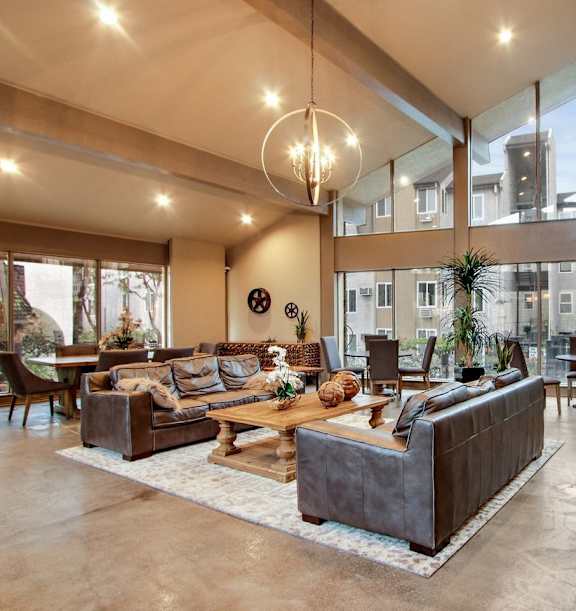 A modern living room with a large window and a wooden coffee table.