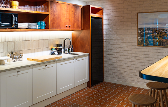 a kitchen with a long counter and bar stools
