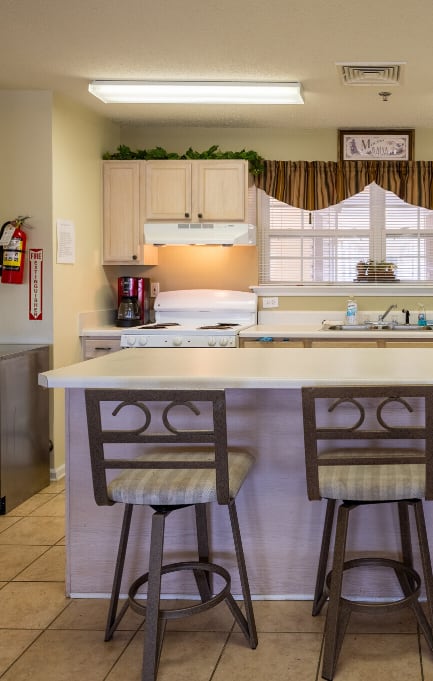 A spacious room with a ceiling fan and wooden flooring.