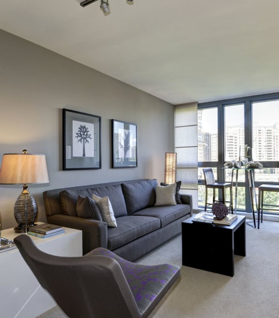 a living room with a couch and a tv and a balcony