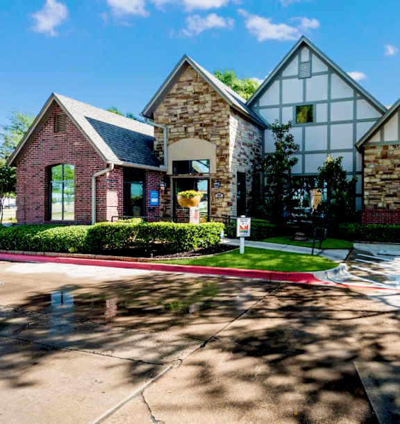 Fusion Crossroads Apartments leasing office exterior with red and brown brick