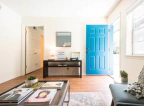 living room with a blue door and a couch at THE EASTWOOD, AUSTIN, 78705