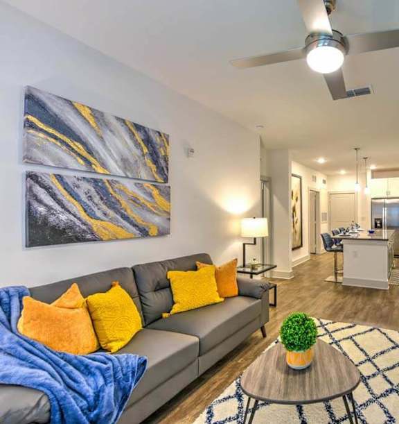 A living room with a couch, chairs, and a coffee table.