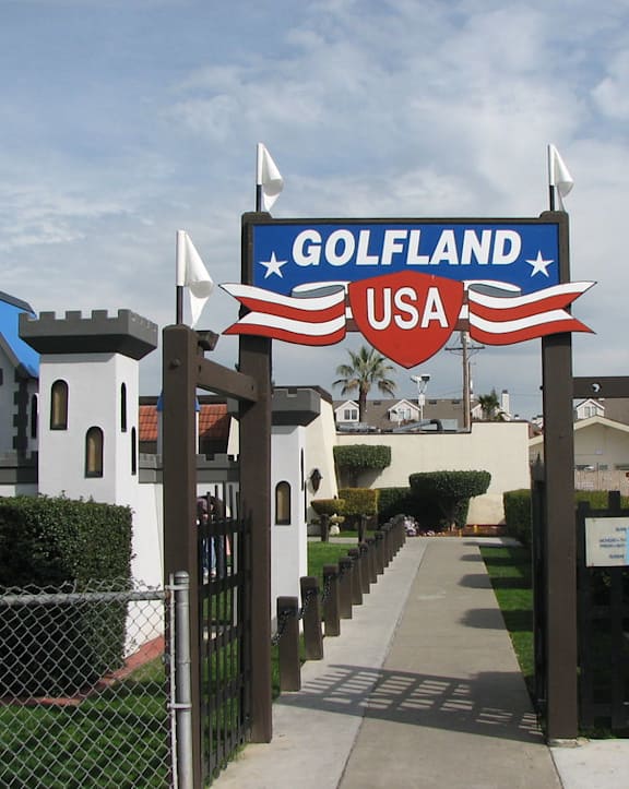 a sign for the golf land usa in front of a house