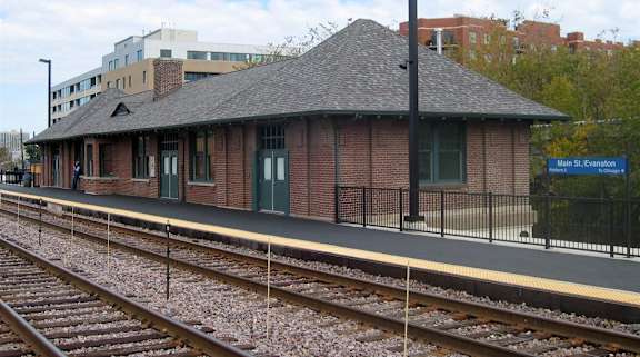 A train station with a sign that says Main St. Evanston.
