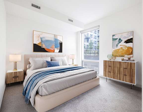 a bedroom with a bed and a large window