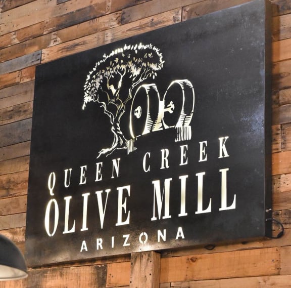a sign for the queen creek olive mill