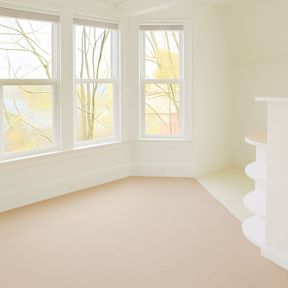 A room with a window and a staircase.