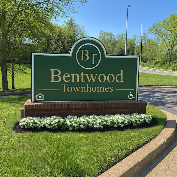A sign for Bentwood Townhomes with a wheelchair symbol indicating accessibility.