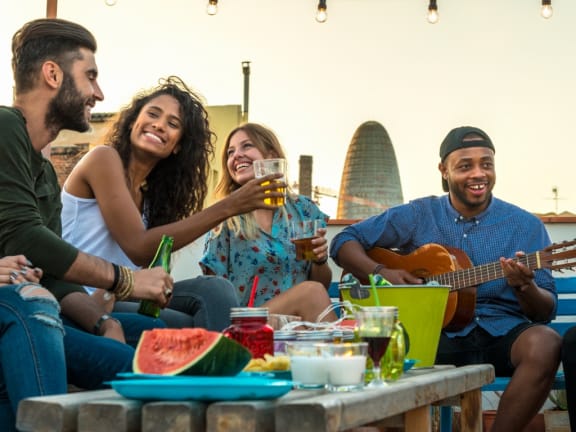 young-adults-celebrating-life-and-friendship-on-a-rooftop at Mid River Clubhouse at Aventura at Mid Rivers, St. Charles, MO
