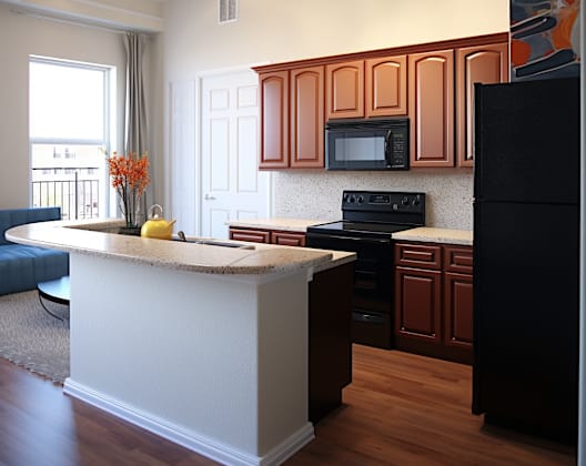 a kitchen with a large island and black appliances