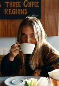 Woman enjoying coffee at Alta Depot, Smyrna