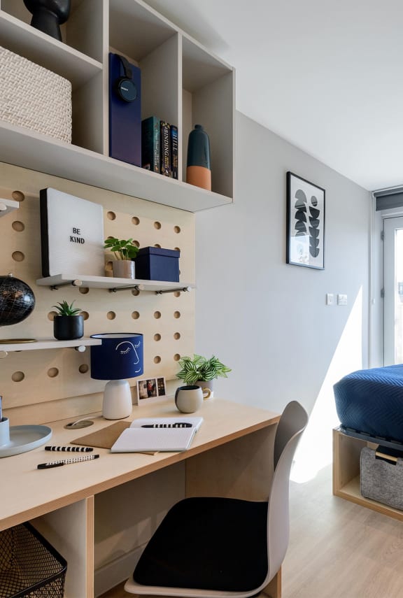 a home office with a desk and a window