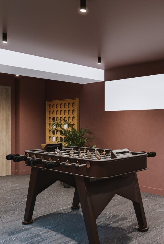 a recreation room with a foosball table and a pool table