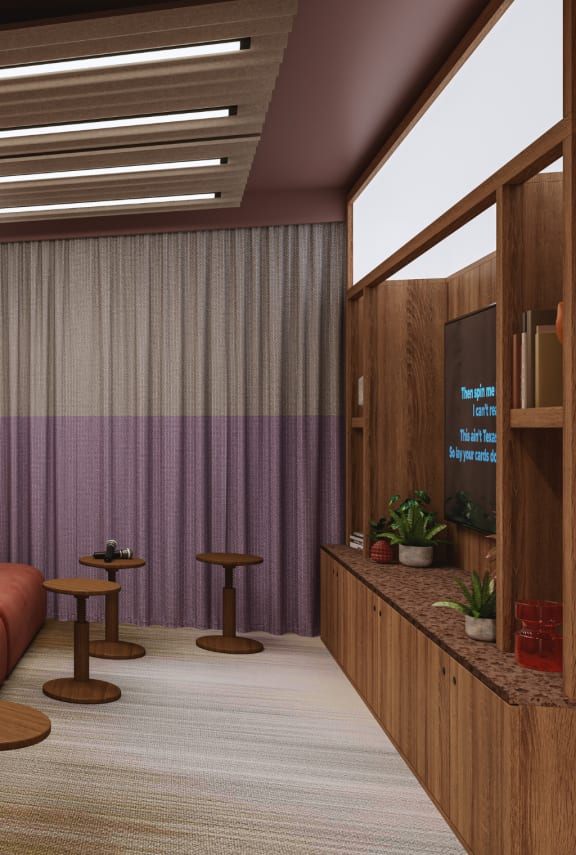 a living room with a blue couch and a tv on the wall