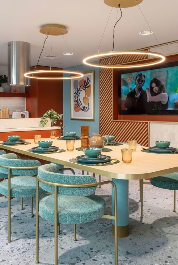 a dining room with tables and chairs and a tv