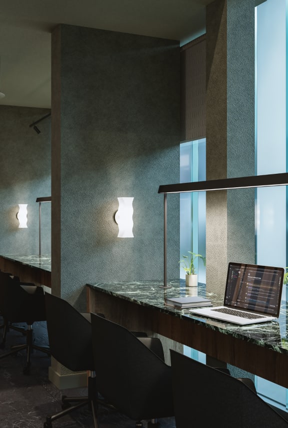 a conference room with a table and chairs and a screen on the wall