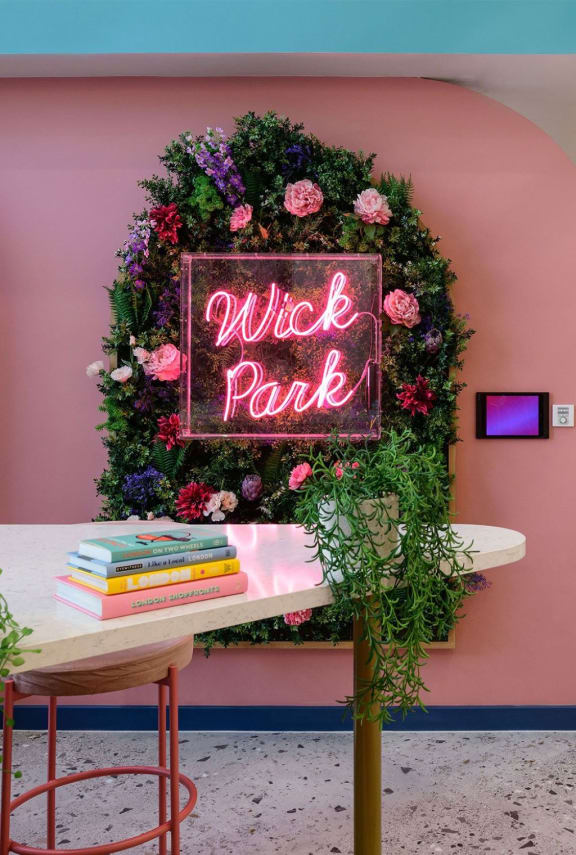a wreath of flowers and a sign on a table in a room