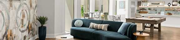A modern living room with a blue sofa and a round coffee table.