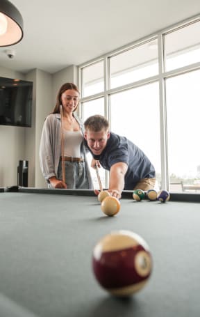 people playing in a clubhouse at a pool table at Current812, Clarksville, IN 47129