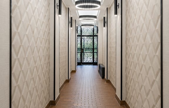 A long corridor with a light hanging from the ceiling.