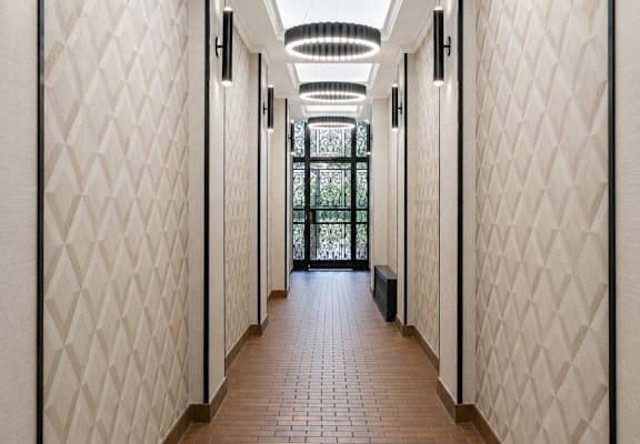 A long corridor with a light hanging from the ceiling.