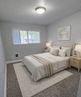 A bedroom with a bed, nightstand, and window.